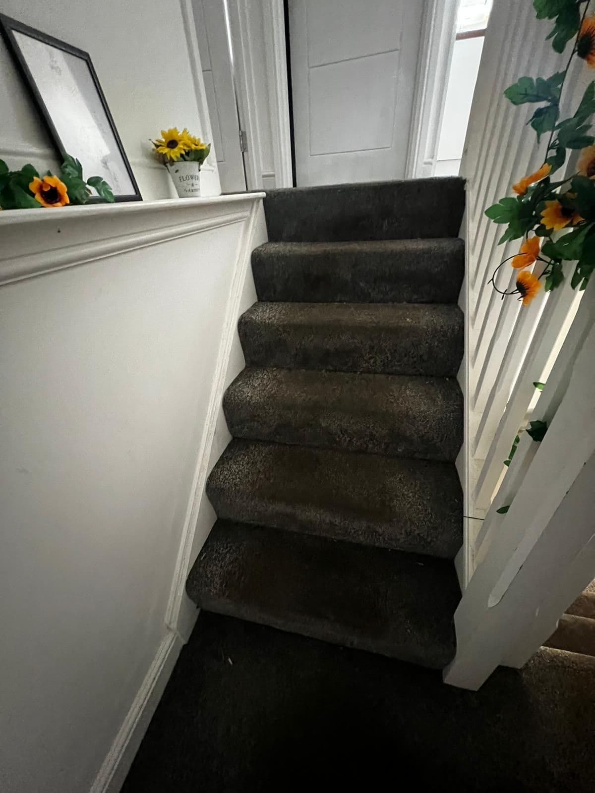 Dark staircase carpet with heavy traffic soiling before professional cleaning