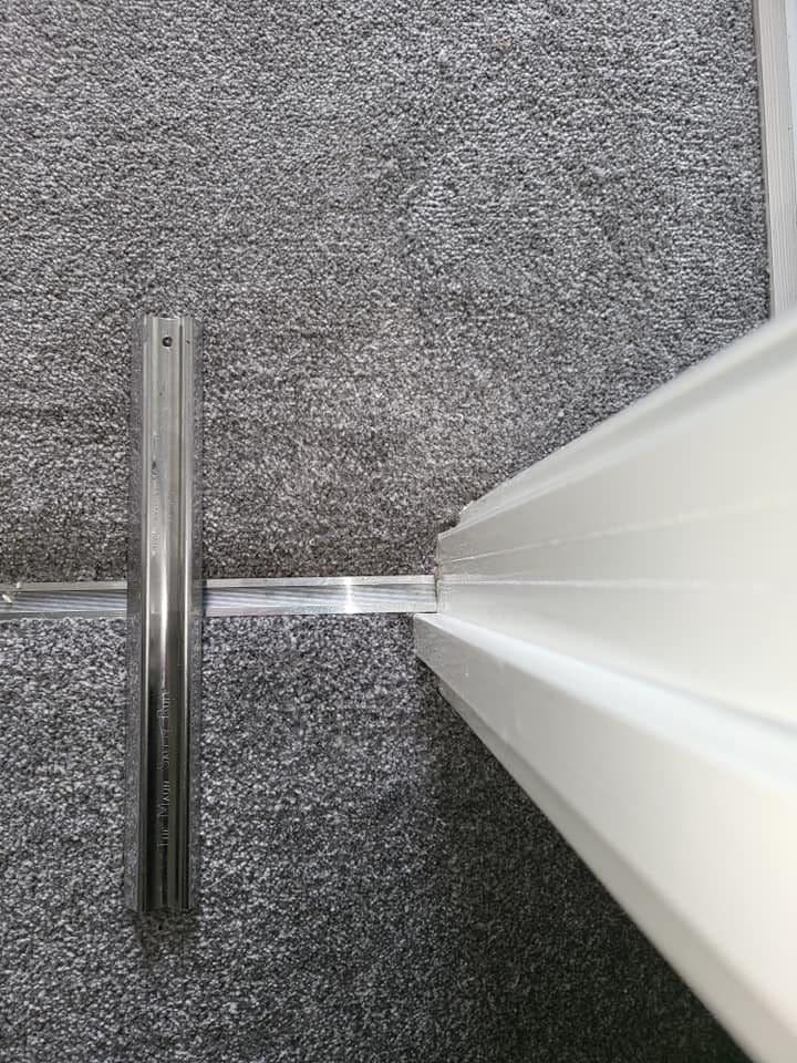 Carpet beside a doorway after George completed a patch repair