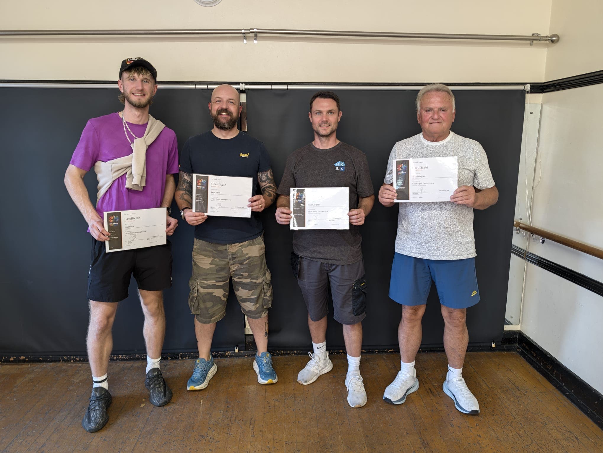 Four graduates holding certificates after George’s hands-on carpet repair course on 25 September.