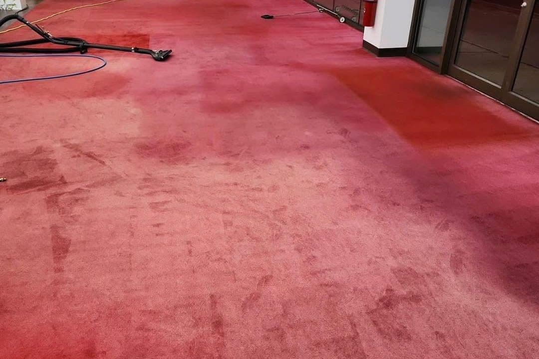 Red carpet before professional carpet re-dyeing