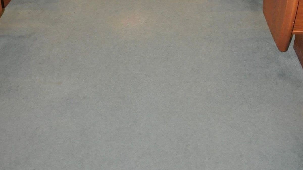 Church aisle carpet before professional colour restoration