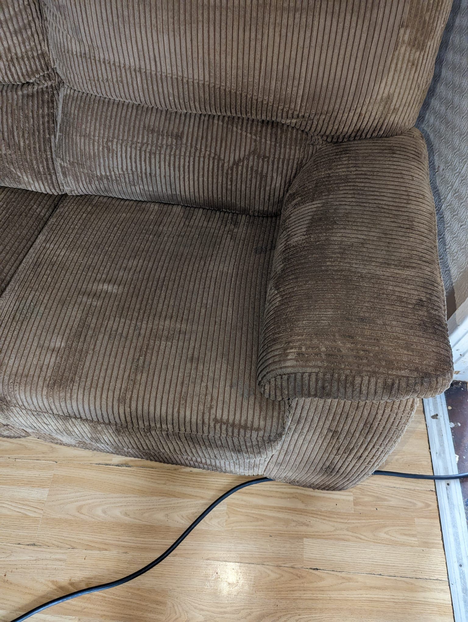 Cord-upholstered sofa arm before professional upholstery cleaning