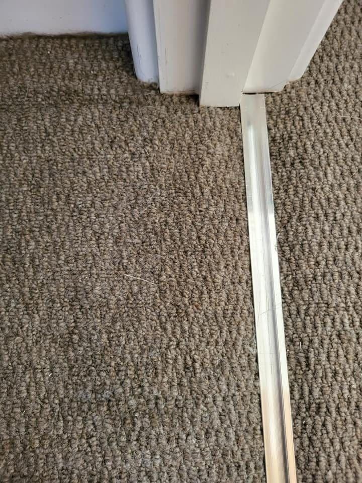 Doorway carpet after George completed a matching patch repair